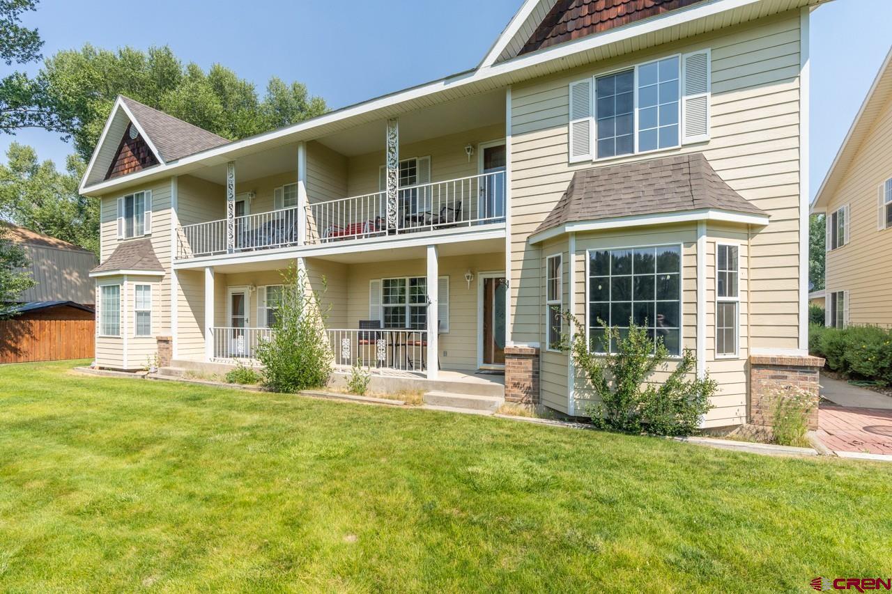 37480 Highway 50, Unit 2 Gunnison, CO 81230 - Photo 1 of 27 front view of a house with a yard