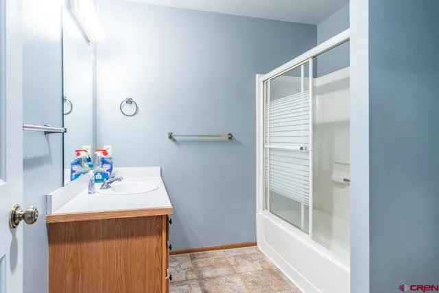 a bathroom with a sink a mirror and a shower