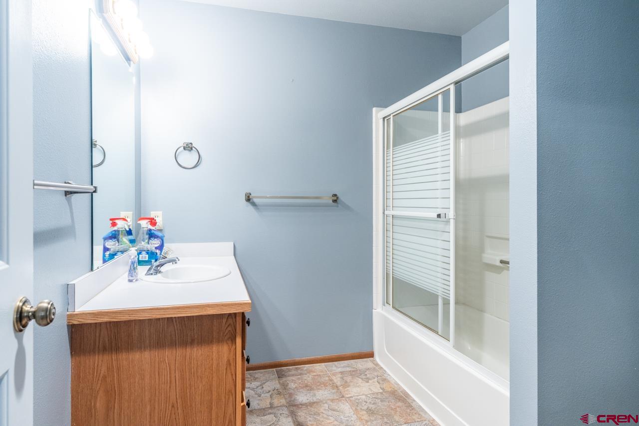 37480 Highway 50, Unit 2 Gunnison, CO 81230 - Photo 12 of 27 a bathroom with a sink a mirror and a shower