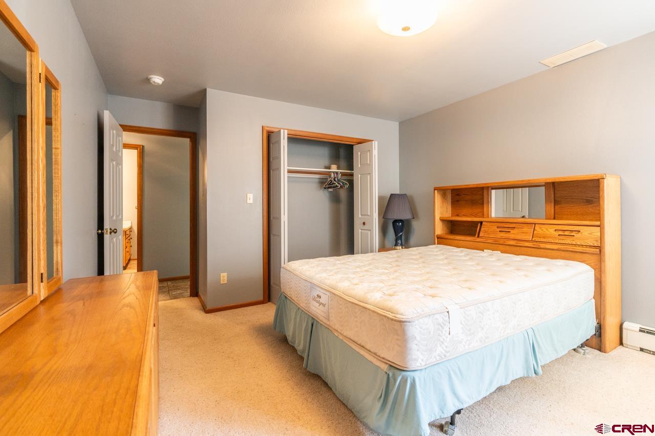 37480 Highway 50, Unit 2 Gunnison, CO 81230 - Photo 14 of 27 a bedroom with a large bed and dresser