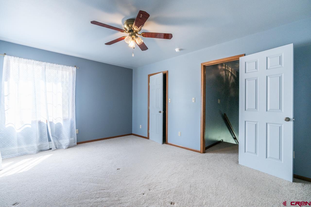 37480 Highway 50, Unit 2 Gunnison, CO 81230 - Photo 19 of 27 an empty room with closet and windows