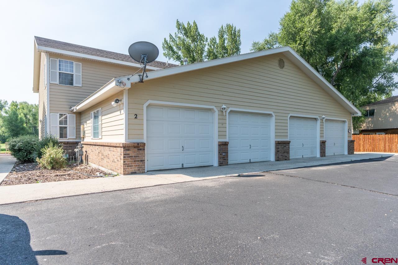 37480 Highway 50, Unit 2 Gunnison, CO 81230 - Photo 2 of 27 a front view of house with yard and trees in the background