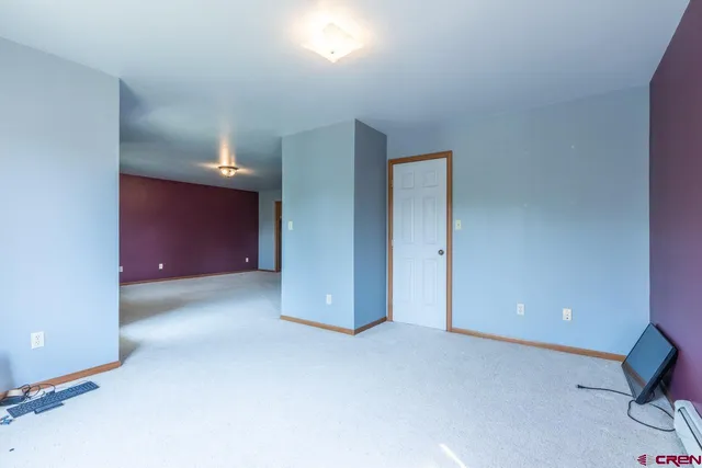 an empty room with closet and mirrors