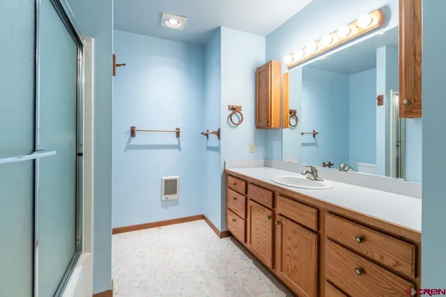 a bathroom with a double vanity sink and mirror