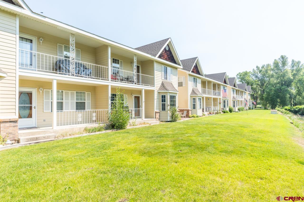 37480 Highway 50, Unit 2 Gunnison, CO 81230 - Photo 27 of 27 a front view of a building with a garden and swimming pool