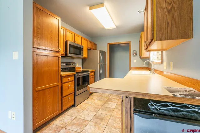 a kitchen with a sink appliances and cabinets