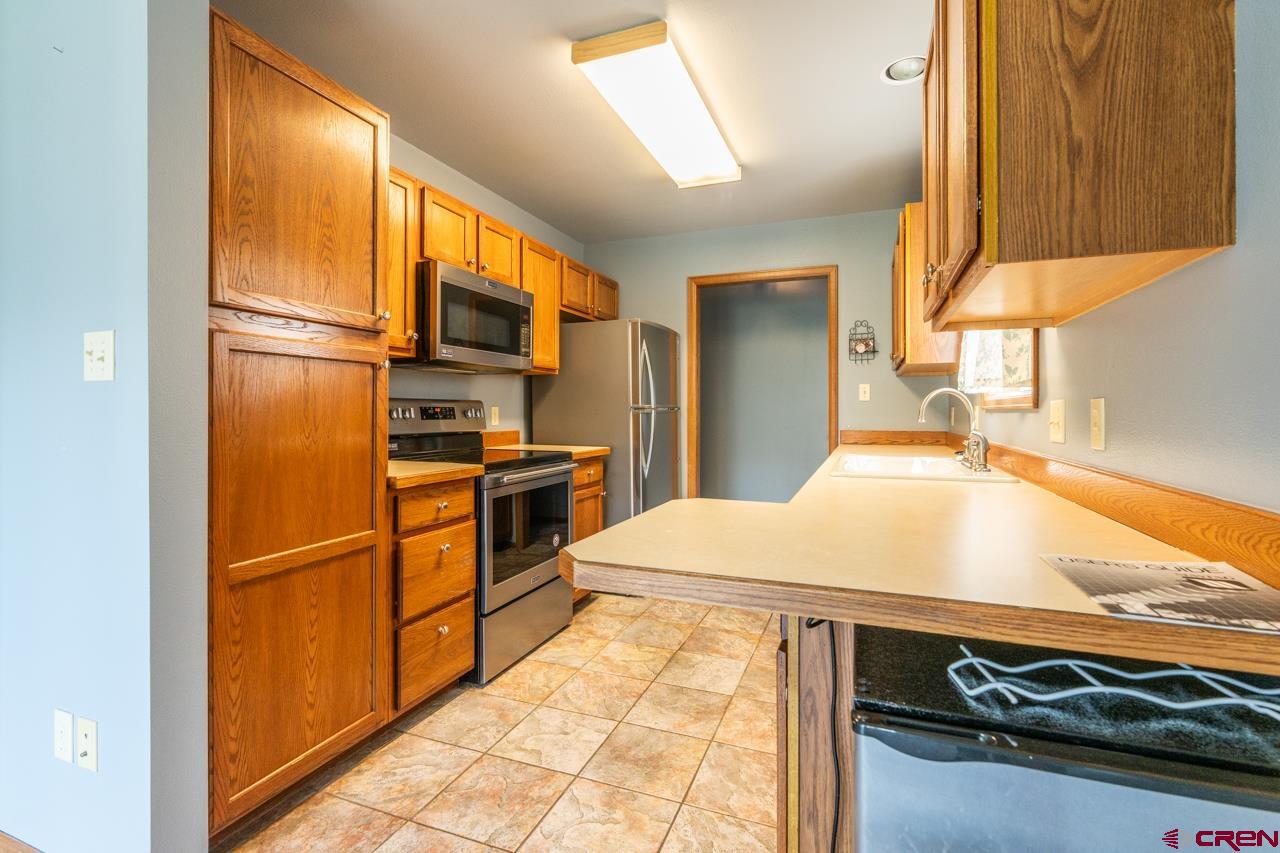 37480 Highway 50, Unit 2 Gunnison, CO 81230 - Photo 6 of 27 a kitchen with a sink appliances and cabinets