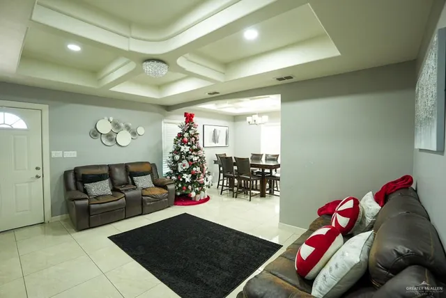 a living room with furniture gym equipment and a chandelier