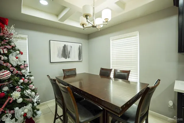 a view of a dining room with a table and chairs