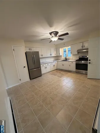 a large kitchen with cabinets and stainless steel appliances