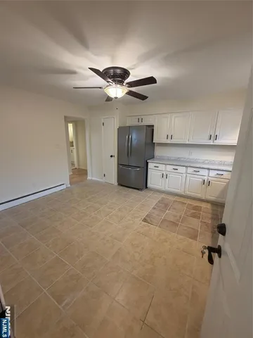 a view of a kitchen with a sink and cabinets