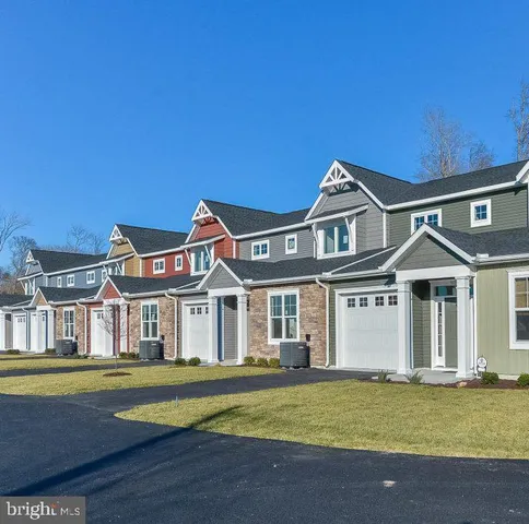 a front view of a house with a garden and swimming pool