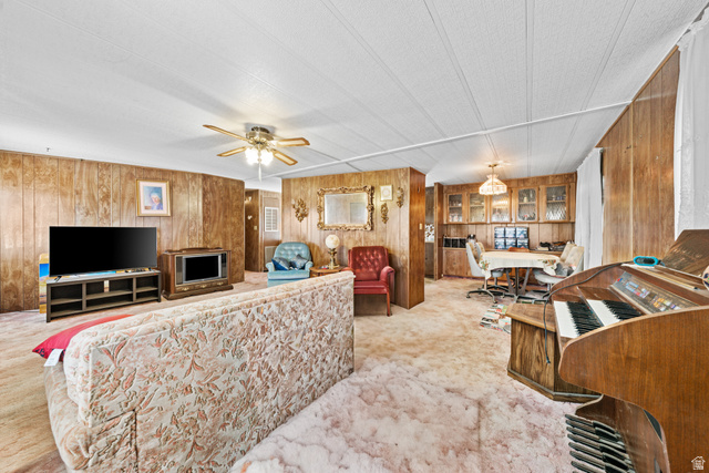 49 600 North Hurricane, UT 84737 - Photo 3 of 33 Living area with wooden walls, light carpet, a desk, and ceiling fan