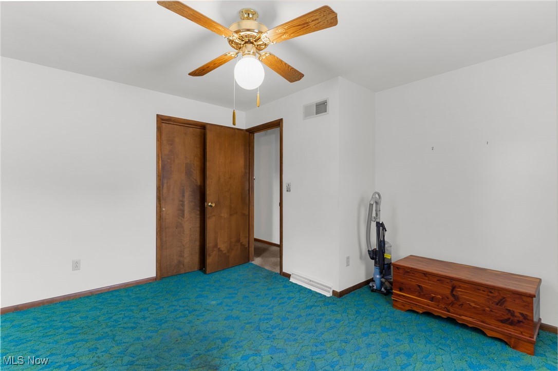 1295 Shields Road Youngstown, OH 44511 - Photo 15 of 27 Carpeted spare room featuring ceiling fan and baseboards