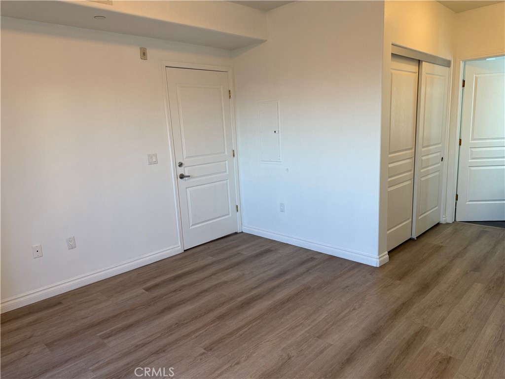 11 South 3rd Street, Unit 218 Alhambra, CA 91801 - Photo 12 of 21 a view of an empty room with wooden floor