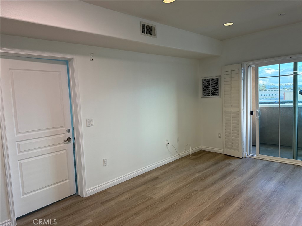 11 South 3rd Street, Unit 218 Alhambra, CA 91801 - Photo 16 of 21 a view of an empty room with wooden floor