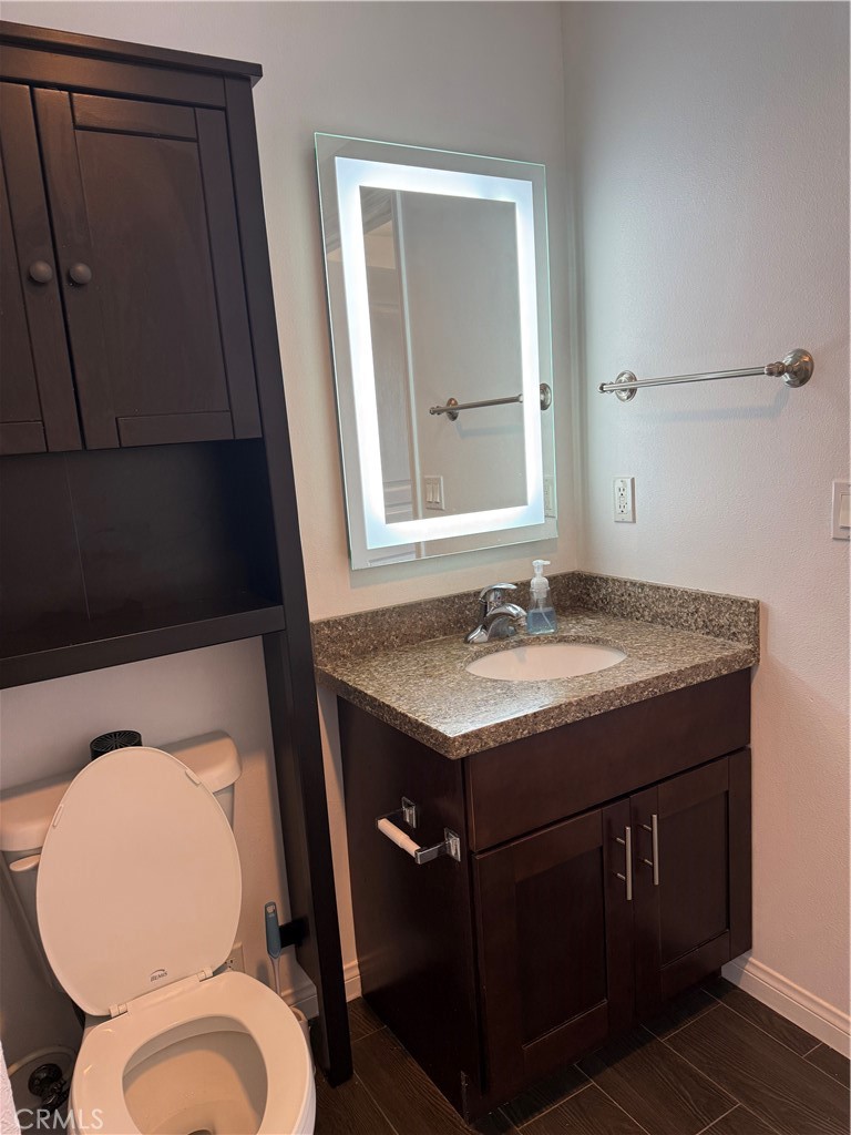 11 South 3rd Street, Unit 218 Alhambra, CA 91801 - Photo 17 of 21 a bathroom with a granite countertop toilet sink and mirror