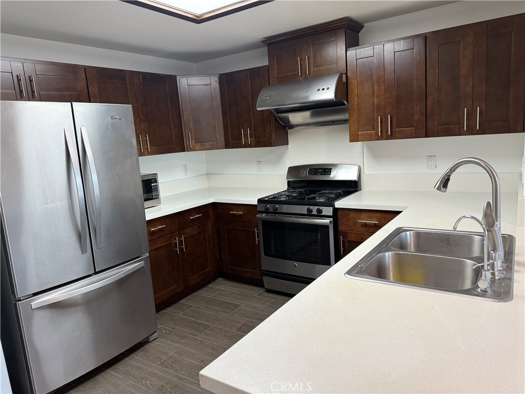 11 South 3rd Street, Unit 218 Alhambra, CA 91801 - Photo 2 of 21 a kitchen with stainless steel appliances a refrigerator stove and sink