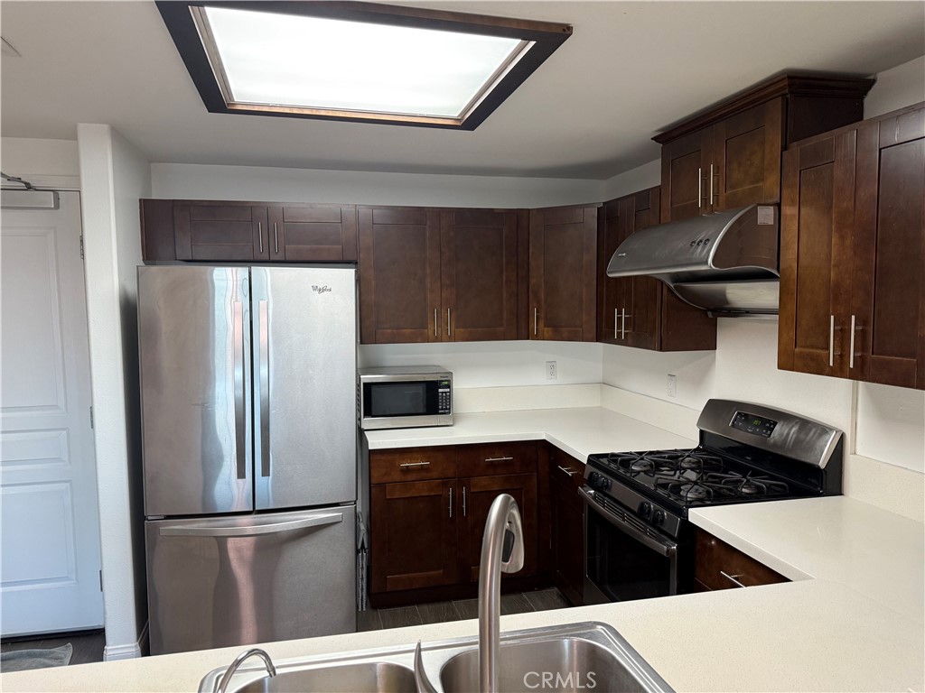 11 South 3rd Street, Unit 218 Alhambra, CA 91801 - Photo 21 of 21 a kitchen with stainless steel appliances granite countertop a refrigerator and a stove top oven