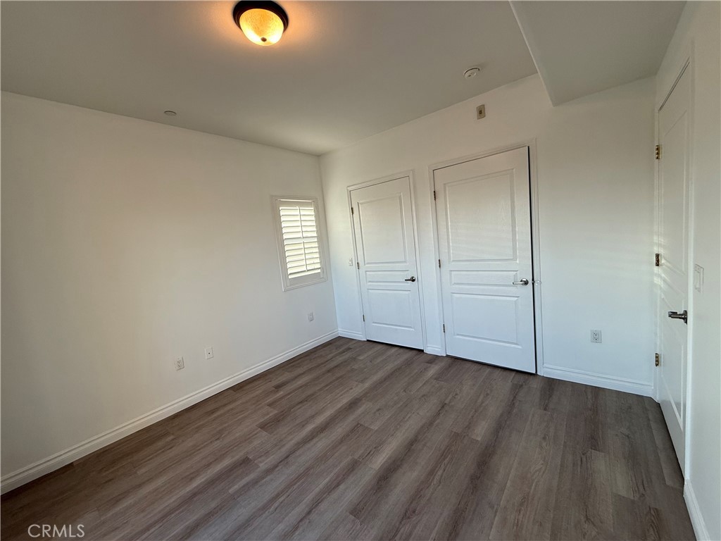11 South 3rd Street, Unit 218 Alhambra, CA 91801 - Photo 6 of 21 a view of an empty room with wooden floor and window