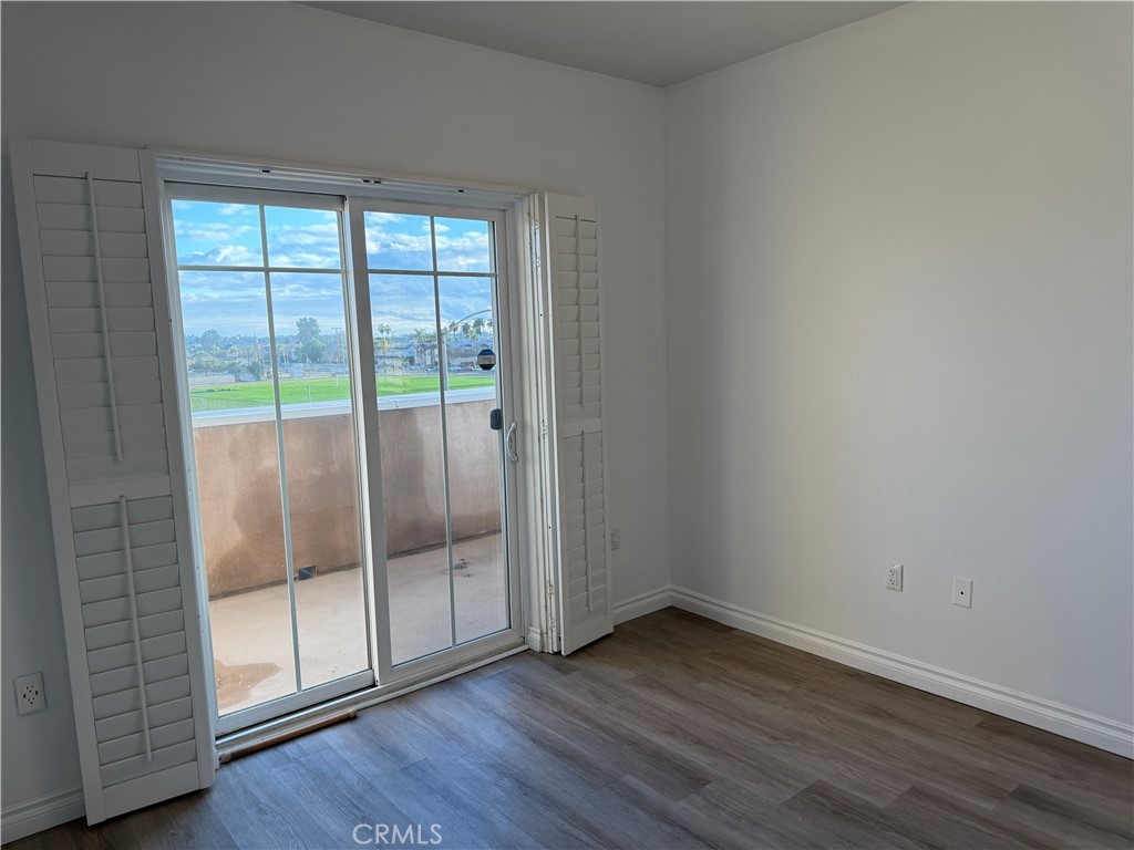 11 South 3rd Street, Unit 218 Alhambra, CA 91801 - Photo 8 of 21 an empty room with wooden floor and door
