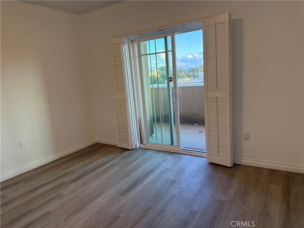 11 South 3rd Street, Unit 218 Alhambra, CA 91801 - Photo 9 of 21 a view of an empty room with wooden floor and a window