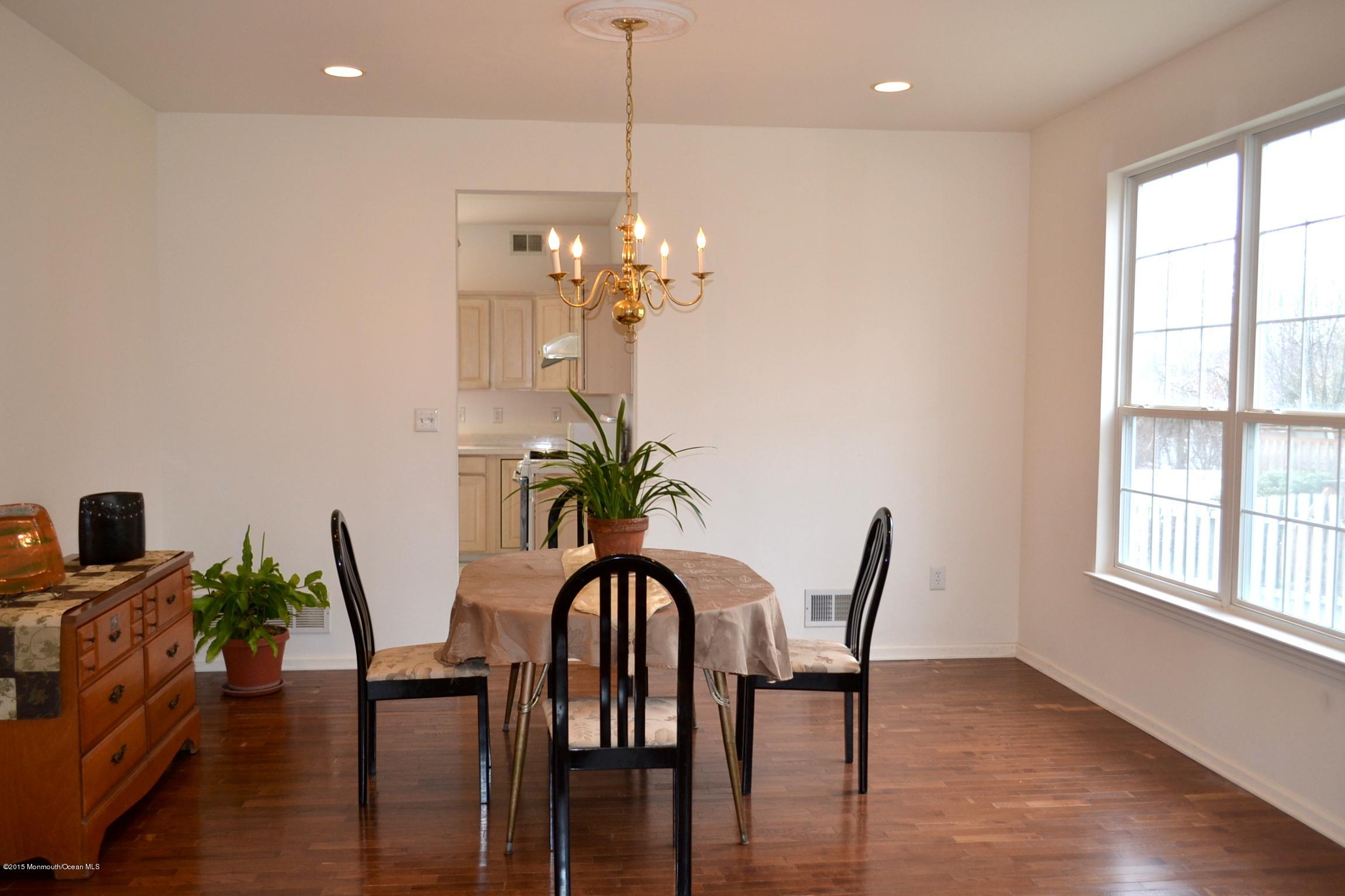 23 Bernadette Road Morganville, NJ 07751 - Photo 4 of 26 a view of a dining room with furniture window and wooden floor