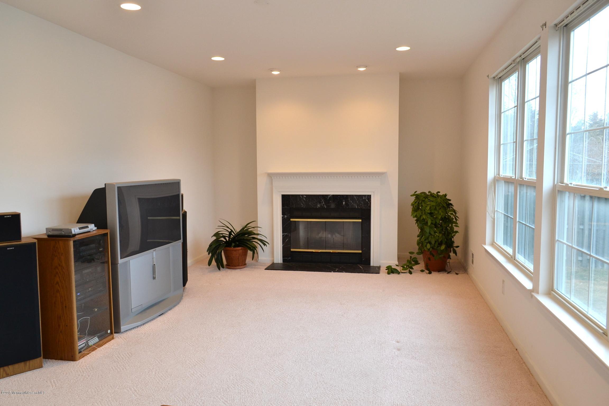 23 Bernadette Road Morganville, NJ 07751 - Photo 9 of 26 a view of livingroom with furniture and fireplace