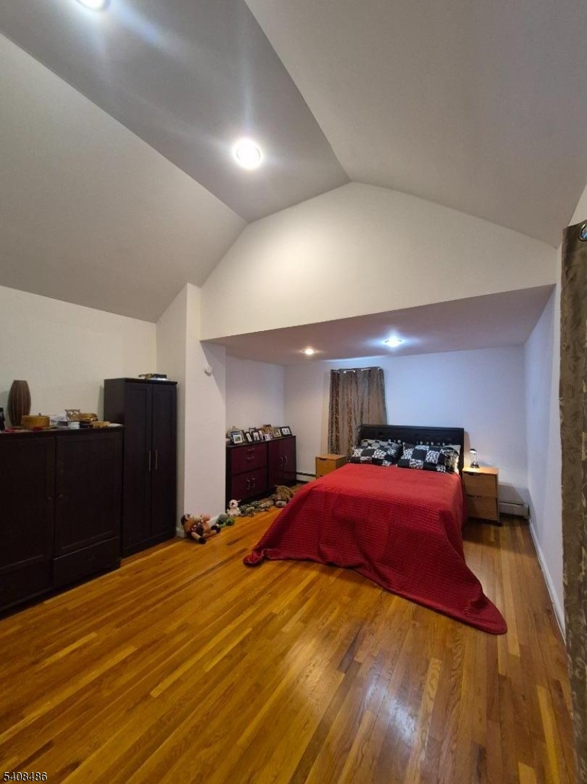 67 Marne Street Newark, NJ 07105 - Photo 11 of 18 a bedroom with a bed and mirror