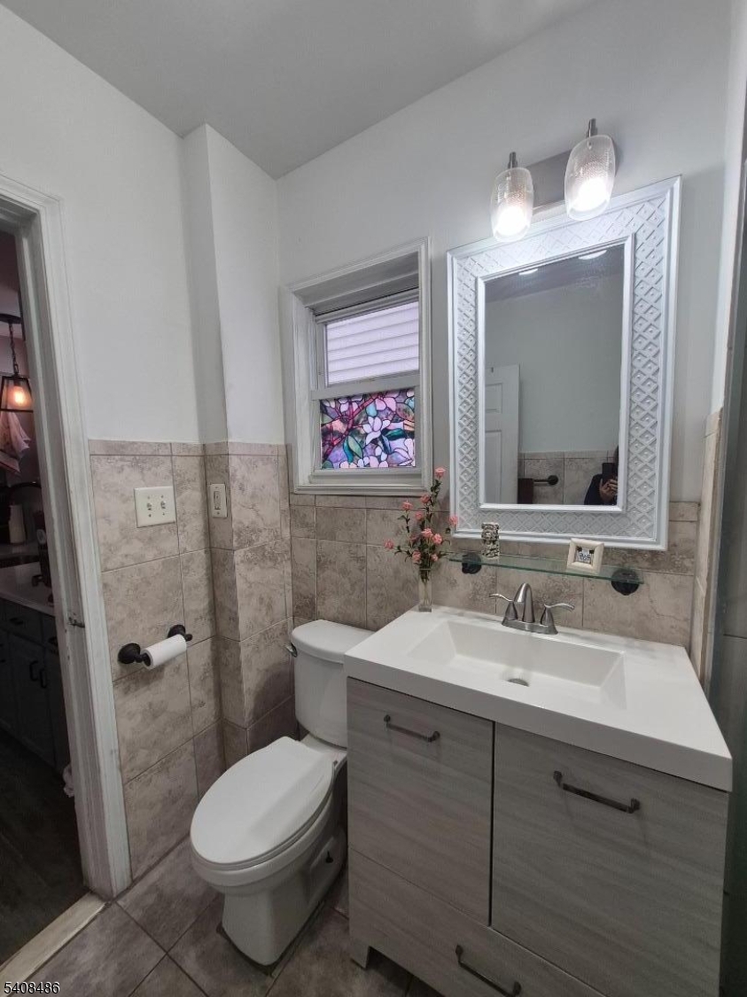 67 Marne Street Newark, NJ 07105 - Photo 13 of 18 a bathroom with a toilet sink and mirror