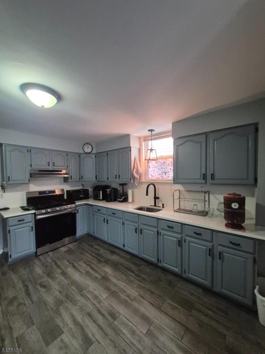 67 Marne Street Newark, NJ 07105 - Photo 7 of 18 a large kitchen with stainless steel appliances and a sink