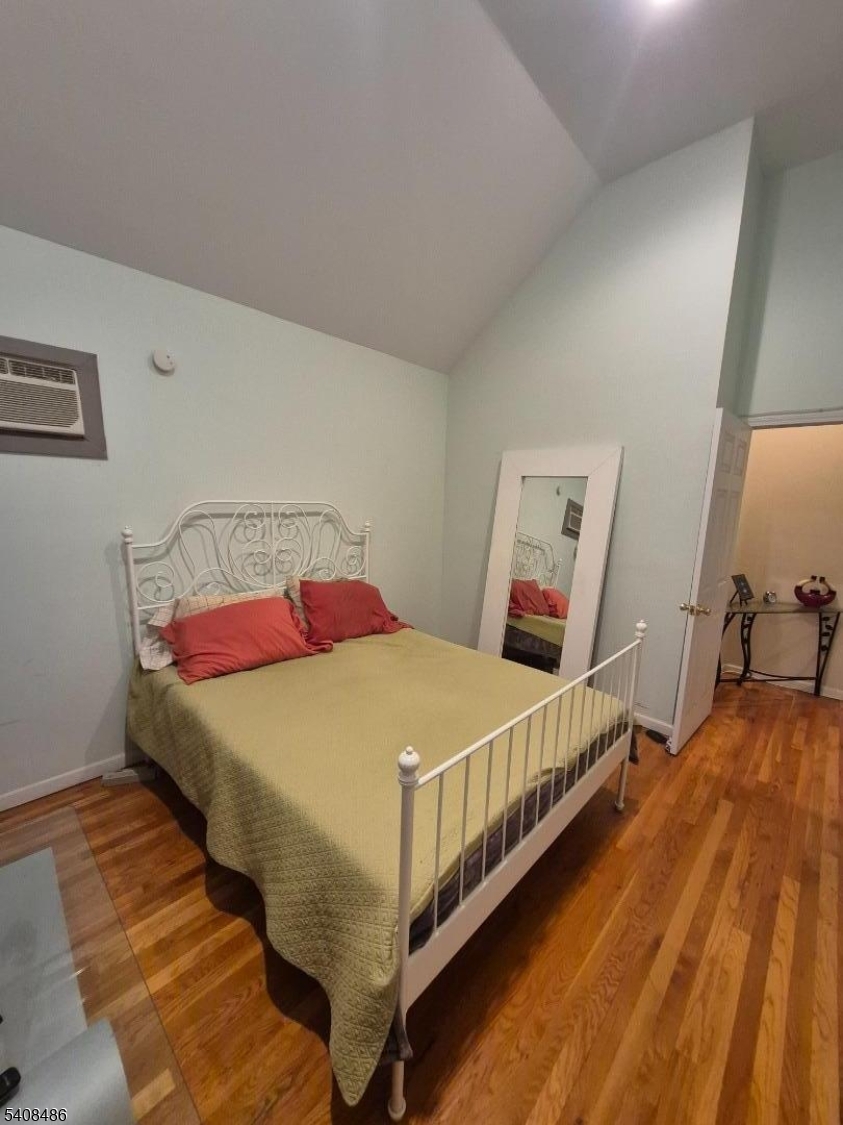 67 Marne Street Newark, NJ 07105 - Photo 10 of 18 a bedroom with a bed and a large mirror on the dresser