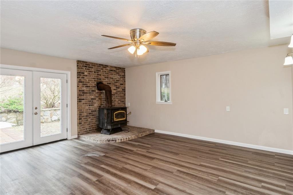 218 Chestnut Lane Chalk Hill, PA 15421 - Photo 6 of 18 an empty room with wooden floor fan and windows