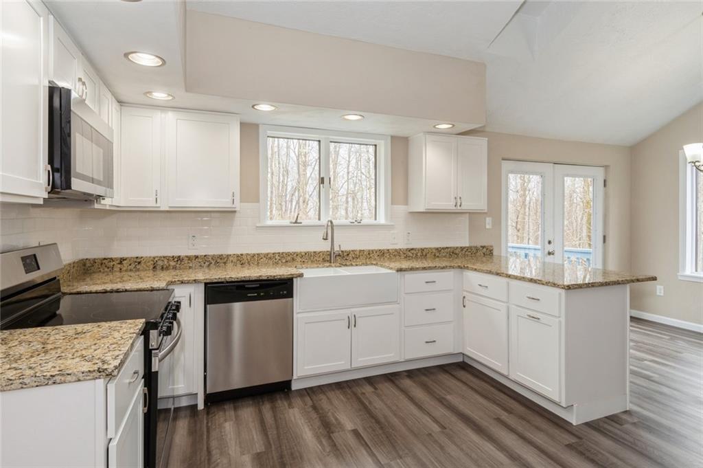218 Chestnut Lane Chalk Hill, PA 15421 - Photo 7 of 18 a kitchen with granite countertop white cabinets and white appliances