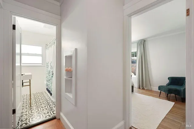 a bathroom with a shower curtain and a window