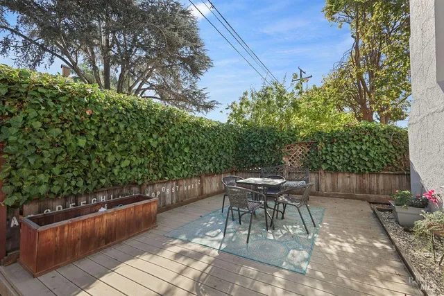 a view of a chairs and tables in the back yard of the house