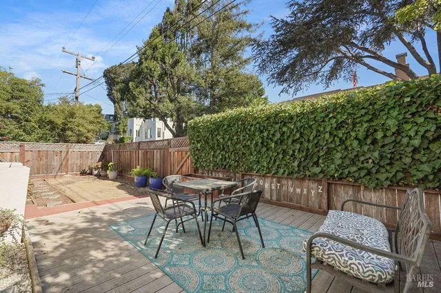 a vase of flowers sitting on a floor in front of a door
