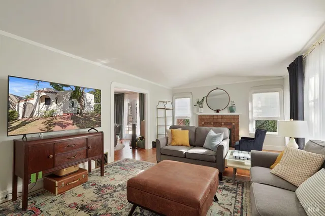 a living room with furniture a rug and a flat screen tv