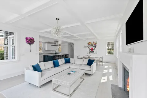 a living room with furniture a fireplace and flat screen tv