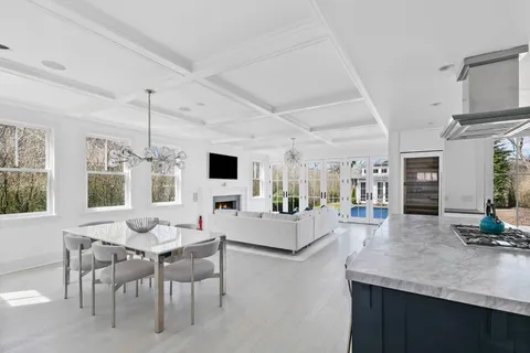 a living room with fireplace furniture and a large window