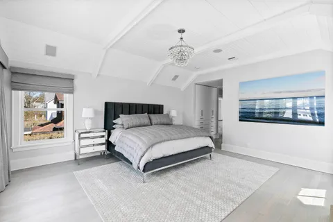 a bedroom with a large bed and a window