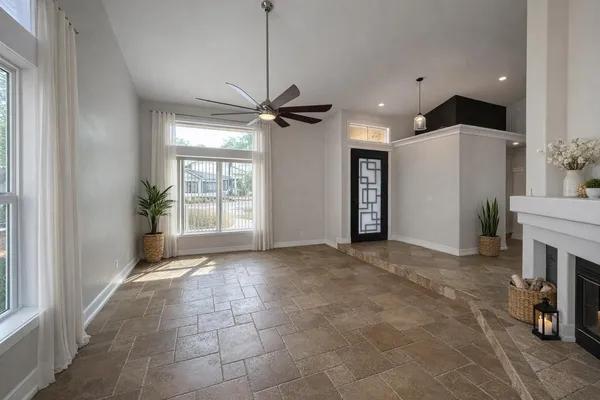 a view of an empty room with a fireplace and a window