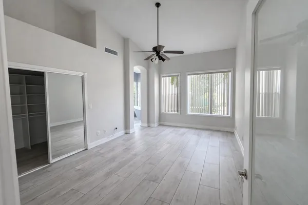 wooden floor in an empty room with a window