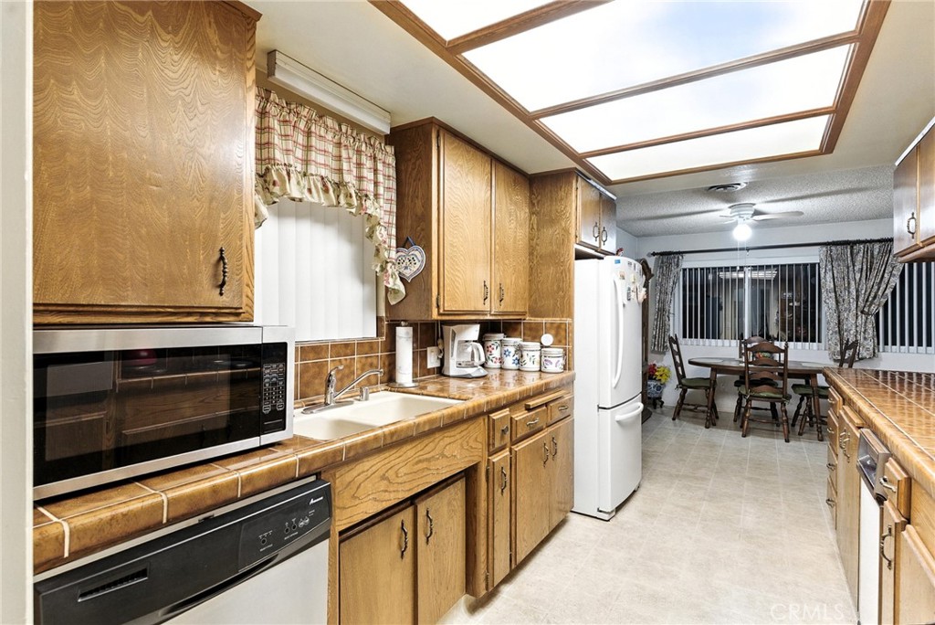 2924 Raccoon Drive Lake Isabella, CA 93240 - Photo 12 of 33 a kitchen with stainless steel appliances kitchen island granite countertop a stove and a microwave