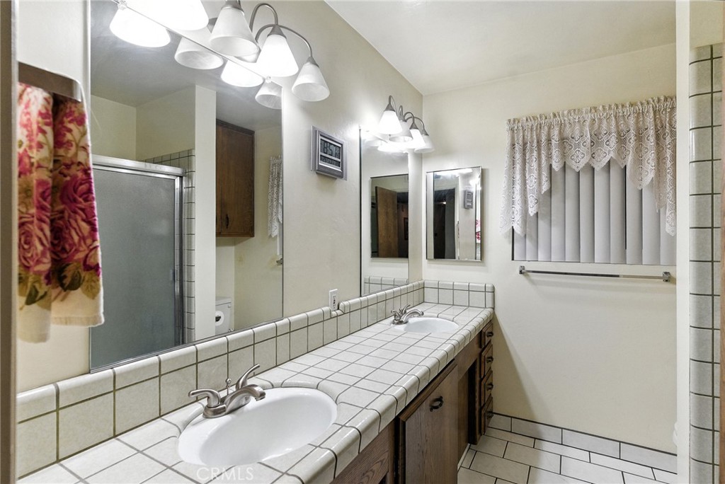 2924 Raccoon Drive Lake Isabella, CA 93240 - Photo 20 of 33 a bathroom with a granite countertop sink and a mirror