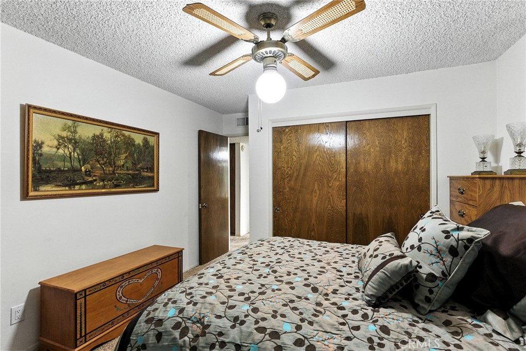 2924 Raccoon Drive Lake Isabella, CA 93240 - Photo 22 of 33 a bedroom with a bed and a chandelier