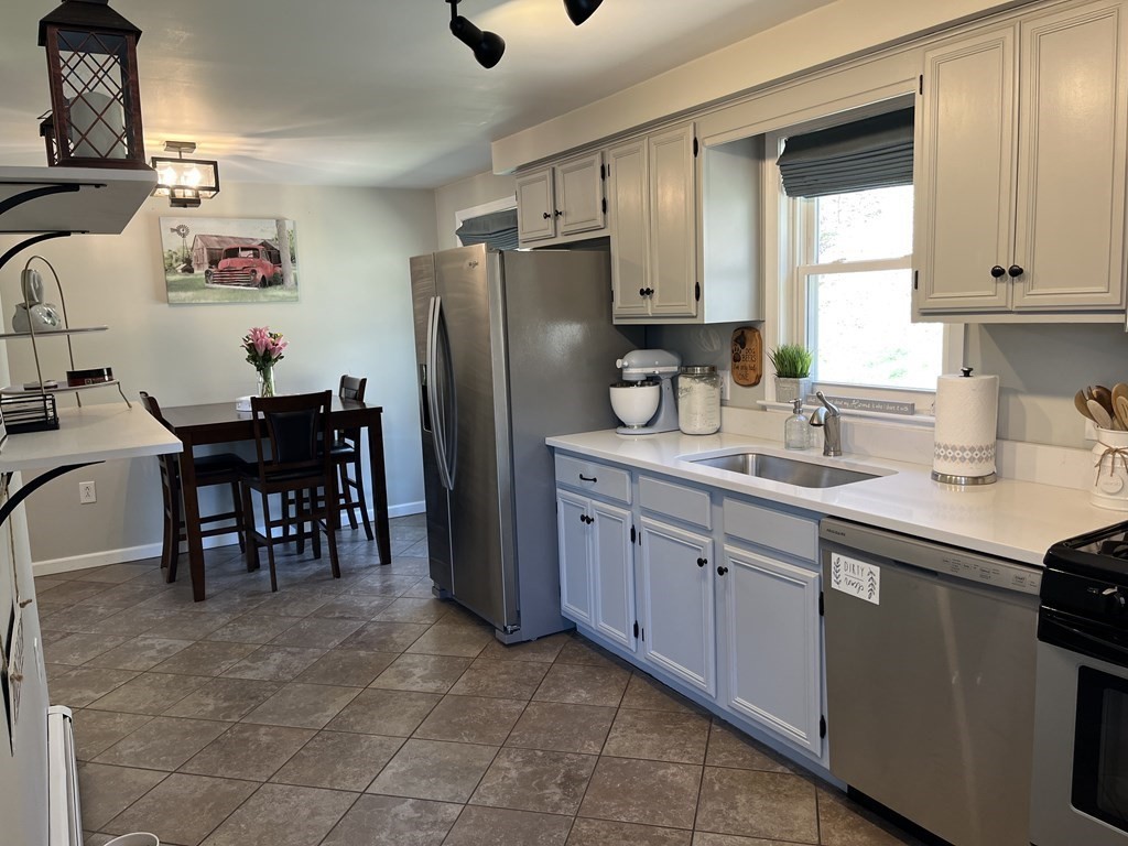 86 East Buckland Road Buckland, MA 01370 - Photo 13 of 39 a kitchen with granite countertop cabinets a window and stainless steel appliances