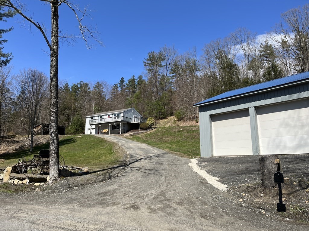 86 East Buckland Road Buckland, MA 01370 - Photo 2 of 39 a front view of a house with a yard and garage