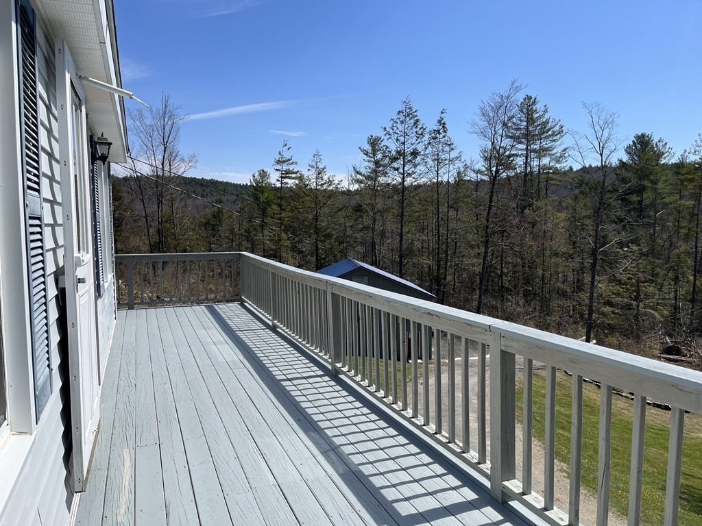 86 East Buckland Road Buckland, MA 01370 - Photo 30 of 39 a view of balcony with wooden floor and trees in the background