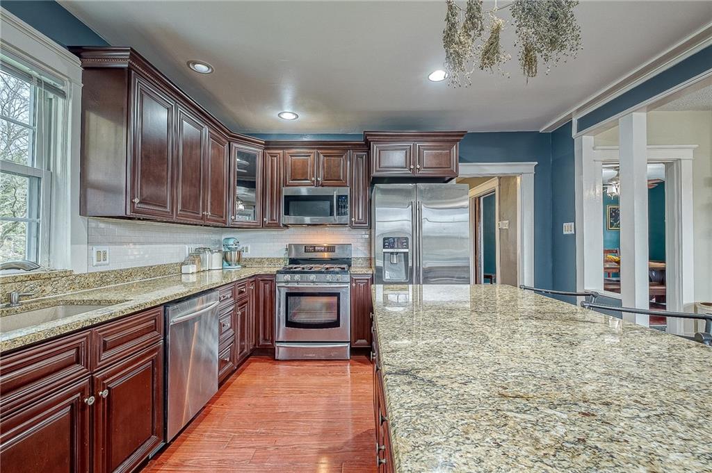7520 Noblestown Road McDonald, PA 15057 - Photo 5 of 25 a large kitchen with stainless steel appliances granite countertop wooden cabinets a sink and dishwasher